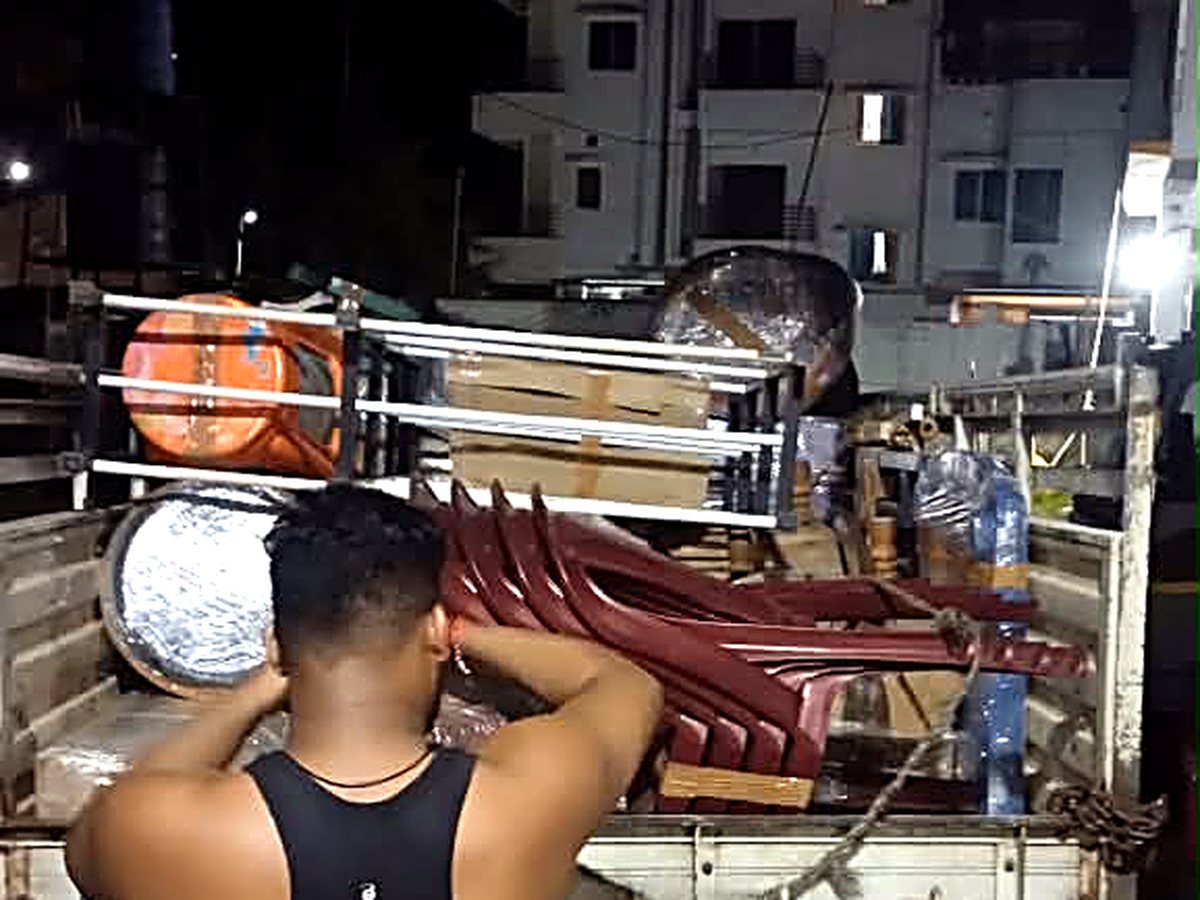Guwahati → Kolkata — packed and stacked household goods ready to move.